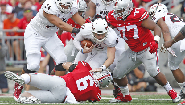Ohio State defensive linemen Sam Hubbard (6) and Michael Hill (77) take down Northern Illinois quarterback Drew Hare (12) on a third down in the second quarter at Ohio Stadium in Columbus on Saturday. (MCT Direct Photo)