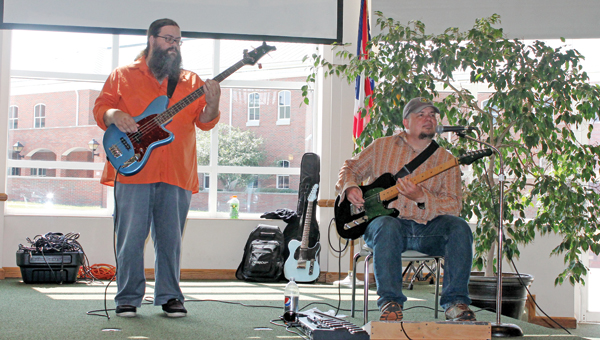 Mothman members Chuck Queen (left) and Todd Martin play a variety of music Wednesday afternoon in the Mains Rotunda at Ohio University Southern at the first concert of the OUS Brown Bag concert series.