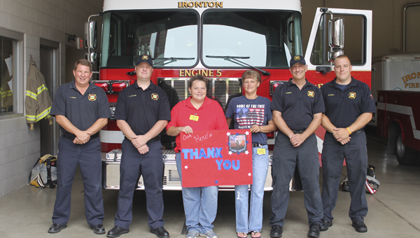 Amy Moore and Trina Hunt (center) with Cash Express in Russell, delivered thank you posters and cake to the Ironton Fire Department on 9/11. Pictured from the department are Captain Craig Thomas, Aaron Collins, Mike Misner and Zack Kriebel.
