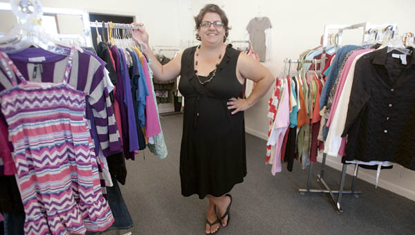 Christine Case stands inside Maxine’s Closet Thrift Shop, located along Third Street, in Chesapeake.
