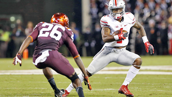 Braxton Miller runs with the ball as Virginia Tech Hokies safety Desmond Frye attempts the tackle. Ohio State beat the Hokies 42-24 on Monday in the season opener. (Geoff Burke/USA TODAY Sports)