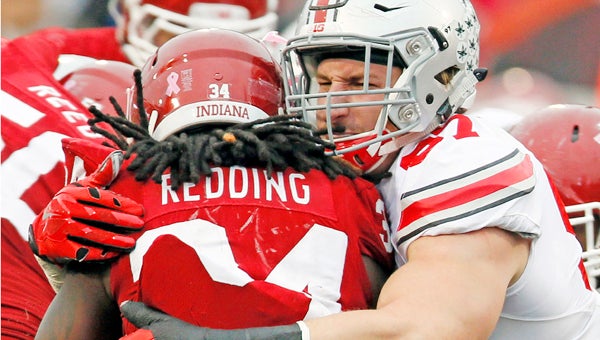 Ohio State defensive lineman Joey Bosa (97) stops Indiana running back Devine Redding (34) in the third quarter at Memorial Stadium in Bloomington, Ind., last Saturday. Bosa has been a major cog in the Buckeyes' defense. (MCT Direct Photo.com)