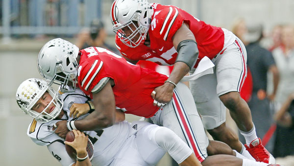 Western Michigan quarterback Zach Terrell (11) is sacked by Ohio State linebackers Raekwon McMillan (5) and Joshua Perry (37) in the second quarter at Ohio Stadium in Columbus last Saturday. The Buckeyes travel to Indiana this Saturday for their Big Ten opener. (MCT Direct Photo.com)