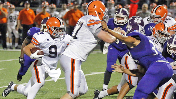 Ironton Fighting TIgers’ running back Garrett Carrico (9) follows the block of Ryan Bryant (87) as he gains yardage in last week’s game at Chesapeake. Ironton plays at South Point on Friday in the regular season finale. The Fighting Tigers can lock up the Ohio Valley Conference title outright with a win. (Tim Gearhart of Tim’s News & Novelties, Park Ave. in Ironton)