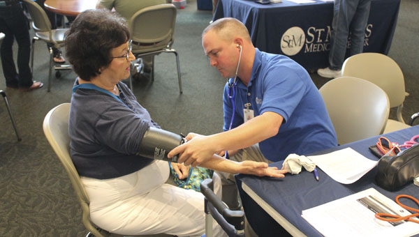 Linda Fraley gets a blood pressure screening Thursday evening at Ohio University Southern during the health fair.