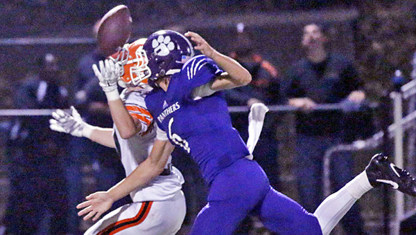 Ironton Fighting Tigers’ end Eli Willis (left) tips a pass to himself en route to a 36-yard touchdown reception during Friday’s Ohio Valley Conference game against the Chesapeake Panthers. Ironton won 21-14 to maintain sole possession of first place. (Tim Gearhart of Tim’s News & Novelties, Park Ave. in Ironton)