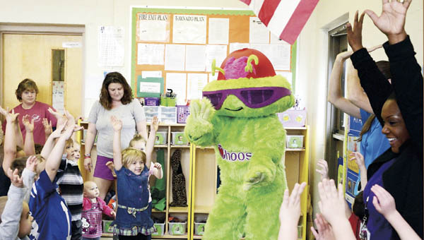 Students at Sybene Preschool dance with Choosy, a mascot who teaches them about healthy eating, as part of the center’s parent engagement event on Thursday.