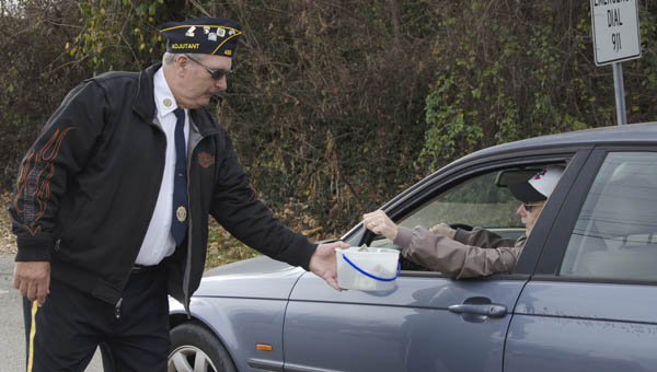 Bill Caines, above, adjutant for American Legion Post 433 in Ironton, collects donations on Friday to assist veterans in Lawrence County nursing homes.