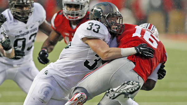 Michigan State’s Jon Reschke (33) sacks Ohio State quarterback J.T. Barrett (16) after Barrett escaped the grasp of the Spartans’ Shilique Calhoun (89) in the second quarter on Saturday at Ohio Stadium in Columbus, Ohio. Michigan State won, 17-14. (Julian H. Gonzalez/Detroit Free Press/TNS)