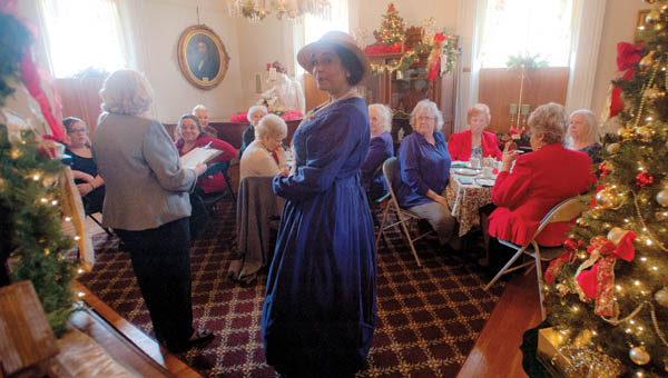 Jackie Dufore plays the part Lavina Ditcher during the Holiday Tea event at the Lawrence County Museum Saturday.