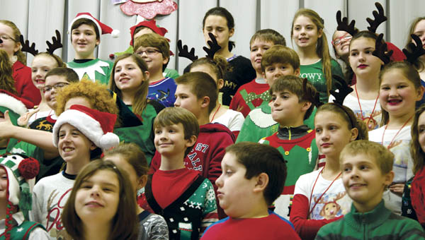 Fifth grade students at Fairland West Elementary rehearse “Crazy Carols,” as part of the school’s annual Christmas program on Tuesday.