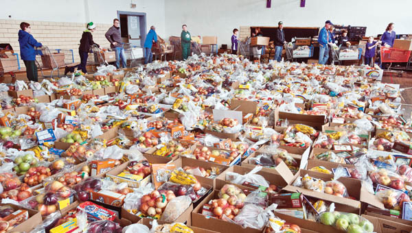 Volunteers gathered in the gymnasium of the Chesapeake Community Center, surrounded by more than 500 food baskets on Tuesday. The baskets were given out to area residents in need.