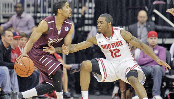 Walsh junior and former Ironton All-Ohio guard and Fighting Tigers’ all-time leading scorer Zac Carter (left) looks for an opening against Ohio State during a preseason exhibition game in which Carter scored 21 points. (Photo courtesy of Walsh University)