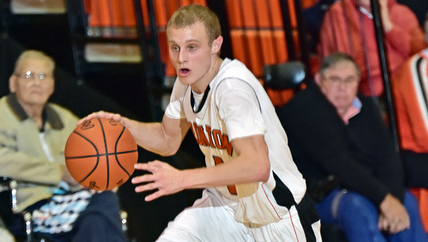 Ironton Fighting Tigers' senior guard Phillip Kratzenberg brings the ball up the court against Columbus Eastmoor during Tuesday's season opener. Ironton won 37-32. (Kent Sanborn of Southern Ohio Sports Photos.com)