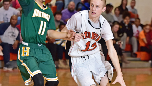 Ironton Fighting Tigers’ guard Ethan Wilson (12) drives past Huntington’s Tavian Dunn-Martin during Tuesday’s game. Ironton just missed an upset of No. 1-ranked Huntington, 58-56. (Kent Sanborn of Southern Ohio Sports Photos)