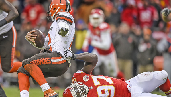 Kansas City Chiefs defensive end Allen Bailey (97) tries to hang on for the tackle of Cleveland Browns quarterback Johnny Manziel (2) during the third quarter on Sunday at Arrowhead Stadium in Kansas City, Mo. Manziel threw for 136 yards and ran for 108 but the Browns lost 17-13. (David Eulitt/Kansas City Star/TNS)