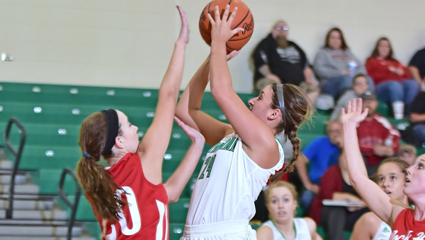 Fairland Lady Dragons’ Taylor Perry (24) takes aim with a shot as Rock Hill Redwomen’s Samantha Dillon (20) attempts to block the shot. Fairland opened the season with a 75-33 Ohio Valley Conference win on Thursday. (Kent Sanborn of Southern Ohio Sports Photos)