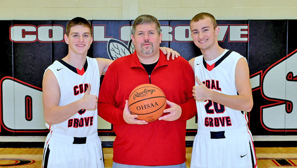 Coal Grove Hornets' first-year head basketball coach Kevin Vanderhoof (center) is flanked by seniors Cole Gannon (3) and Dalton Miller (20). The Hornets beat Gallipolis 60-53 on Tuesday to give Vanderhoof his first career win. (Kent Sanborn of Southern Ohio Sports Photos.com)