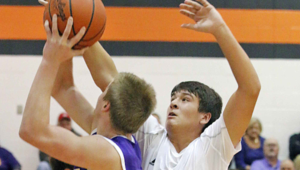 St. Joseph Flyers’ Tyler Ward (35) blocks the shot of Racine Southern's Crenson Rogers during Saturday’s game. The Flyers beat the Tornadoes 64-57 in overtime. (Tim Gearhart of Tim’s News & Novelties, Park Ave. in Ironton)