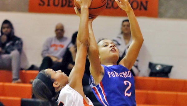 Ironton Lady Fighting Tigers’ Lexie Wise (5) blocks the shot of Portsmouth Lady Trojans’ Kylisha Kearns during Thursday’s Ohio Valley Conference game. Ironton picked up an easy 69-16 win. (Tim Gearhart of Tim’s News & Novelties, Park Ave. in Ironton)