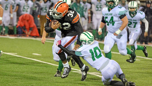Ironton Fighting Tigers' senior fullback and linebacker Desmond Young (32) runs through an attempted tackle during a game last season. Young led 20 area players named to the Associated Press All-Ohio team as he was selected first team defense in Division V. (Kent Sanborn of Southern Ohio Sports Photos.com)