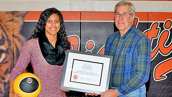 Ironton Lady FIghting Tigers’ senior basketball standout Lexie Barrier (left) is presented a plaque by Steve Cielec of McDonald’s commemorating her selection as a finalist for the prestigious McDonald’s All-American team. (Tony Shotsky of Southern Ohio Sports Photos)