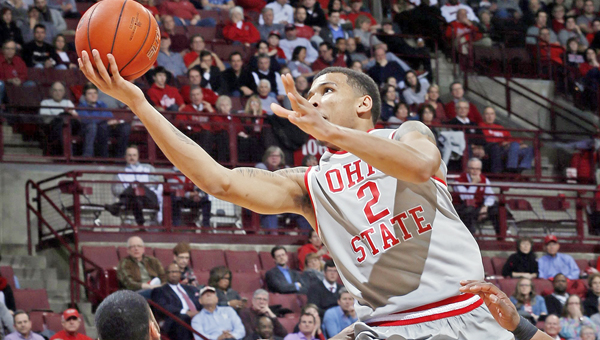 Ohio State forward Marc Loving (2) leaps over Penn State guard Shep Garner (33) to score two points during the second half on Monday at Value City Arena in Columbus, Ohio. (Brooke LaValley/Columbus Dispatch/TNS)
