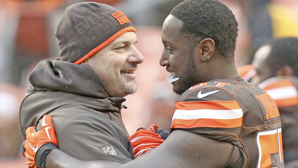 Cleveland Browns head coach Mike Pettine gets a hug from Cam Johnson before the game against the Pittsburgh Steelers on Sunday.Pettine was fired after Sunday’s game along with general manager Ray Farmer. (MCT DIRECT PHOTO)