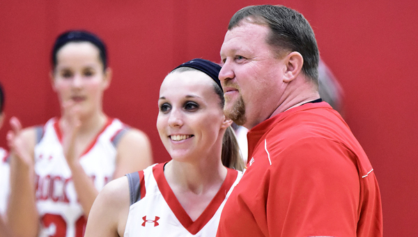Rock Hill Redwomen senior Kaci Russell is presented the game ball by coach Greg Damron after she scored her 1,000th career point on Monday in a 65-31 win over Portsmouth. (Kent Sanborn of Southern Ohio Sports Photos)