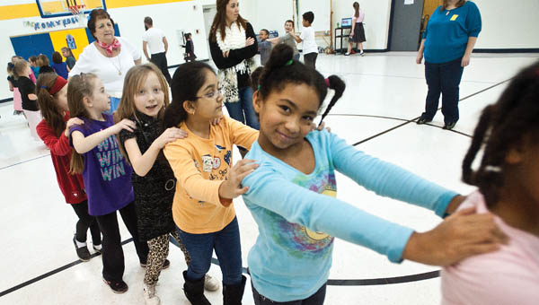 Rachae Patrick is in the conga line during the annual Sock Hop event at Burlington Elementary School Friday.