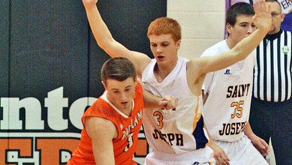 St. Joseph Flyers’ Judge Williams (3) applies defensive pressure to a Raceland player. St. Joseph won 52-33. (Robert S. Stevens & The Gold Studio of Ironton)