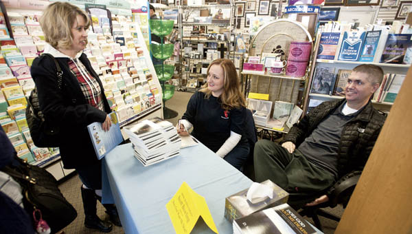 Lawrence County Common Pleas Judge D. Scott Bowling speaks with friend Angie Jenkins during a book signing at the Mustard Seed located at the former K-Mart Plaza in South Point.