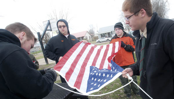 Pictured left to right, Wyatt Boggs, Parker Rowe, Dylan Spurlock and Cory Rawlins, work to put together and erect a new flagpole at the Edna Kopacz Park in Ironton.