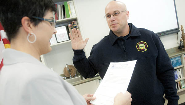 Ironton Mayor Katrina Keith swears in Reggie Besco on Wednesday as the latest addition to the Ironton Fire Department.