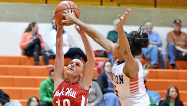 Ironton Lady Fighting Tigers’ Lexie Barrier (right) blocks a shot during Monday’s Ohio Valley Conference game. Ironton beat the Rock Hill Redwomen 82-48 to finish the regular season with their first-ever unbeaten record a 22-0. (Kent Sanborn of Southern Ohio Sports Photos)