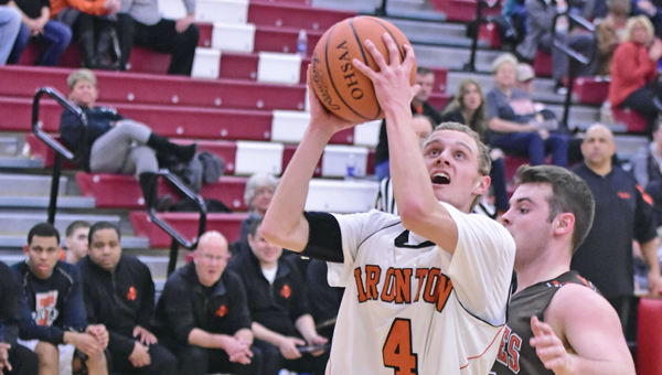 Ironton Fighting Tigers’ Phil Kratzenberg (4) drives past a Nelsonville-York defender to make a layup during Tuesday’s Division III sectional tournament. Ironton won 52-38. (Kent Sanborn of Southern Ohio Sports Photos)