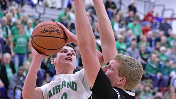 Fairland Dragons’ Gunner Short (52) scores inside against Oak Hill’s Dennis Fleming (50) during the Division III sectional finals on Friday. Fairland won 52-47 and will play in the district semifinals next Sunday in Athens. (Kent Sanborn of Southern Ohio Sports Photos)