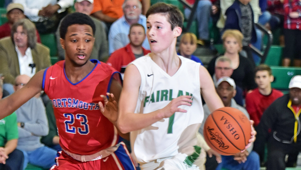 Fairland Dragons’ point guard Ty Staten (1) takes the ball down the lane against Portsmouth’s Dakota Reynolds (23) during Friday’s game. Fairland won 75-72 in overtime to clinch at least a share of the Ohio Valley Conference championship. (Kent Sanborn of Southern Ohio Sports Photos)