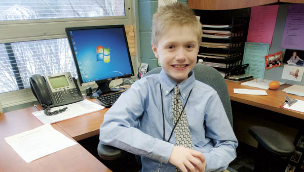 Fourth grader Owen Johnson makes himself right at home in the principal’s office at Dawson-Bryant Elementary School. Owen is one of four at the school who got to play grown-up for the day following an auction for the positions during the school’s fall festival.