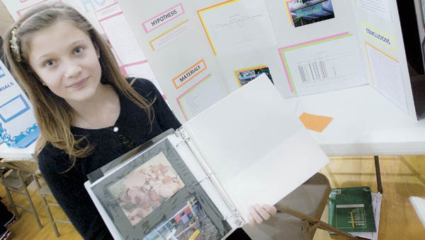 Alyssa Brucham shows off her project dealing with chicken eggs at the Fairland West science fair Friday.