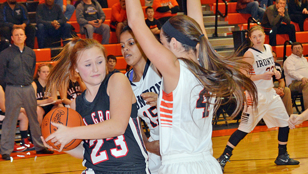 Ironton Lady Fighting Tigers’ Jordan Hannan (4) and Lexie Barrier (15) apply defensive pressure to Coal Grove Lady Hornets’ Lauren Crum (23). Ironton won 53-29. (Tony Shotsky of Southern Ohio Sports Photos)