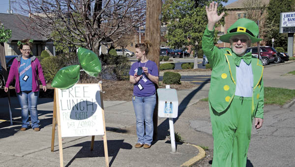 Bob Vinson of Spectrum Outreach waves to passers-by to promote a free lunch and awareness-raising event at the drug and alcohol treatment center in Ironton on Thursday.