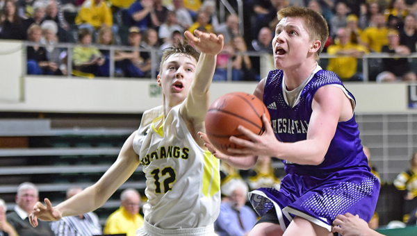 Chesapeake Panthers’ senior guard Gage Stephens (with ball) drives down the middle of the Lynchburg-Clay defense and past Eric McLaughlin (12) during Wednesday’s Division III regional semifinal game. The Panthers lost to the Mustangs 53-48 in overtime. (Kent Sanborn of Southern Ohio Sports Photos)
