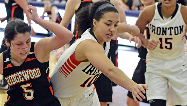Ironton Lady Fighting Tigers’ D’Laynie Keith (10) battles West Lafayette Ridgewood’s Audrey Tingle (5) for a loose ball during last week’s Division III regional championship game. Ironton won and faces Columbus Africentric at 3 p.m. on Thursday in the state semifinals. (Kent Sanborn of Southern Ohio Sports Photos)