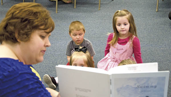 Library assistant Jan Gullett reads to children during Preschool Story Time at the Briggs-Lawrence Public Library in Ironton on Monday.
