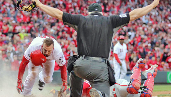 Cincinnati Reds’ pinch-runner Tyler Holt (left) scores the tying run ahead of the attempted tag by Philadelphia Phillies’ catcher Carlos Ruiz. The Reds tied the game at 2-2 in the eighth and scored four more runs to win 6-2 on Opening Day Monday. (Photo Courtesy of The Cincinnati Reds.com)