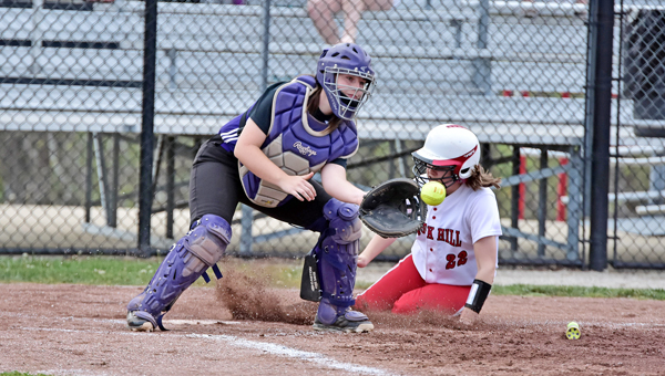Rock Hill Redwomen’s Kelsey Olderman (22) slides into home safely ahead of the tag of Chesapeake Lady Panthers’ catcher Kelsey Huff during Wednesday’s Ohio Valley Conference game. Rock Hill beat the Lady Panthers 12-5. (Kent Sanborn of Southern Ohio Sports Photos)