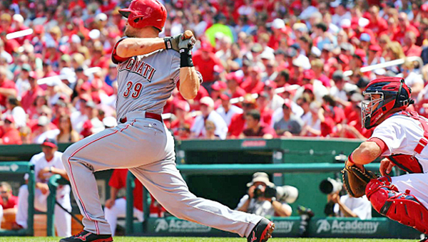 Cincinnati Reds’ catcher Devin Mesoraco hits a run-scoring single in the fourth inning during Sunday’s game. The Reds lost to the St. Louis Cardinals 4-3. (Photo Courtesy of The Cincinnati Reds.com)