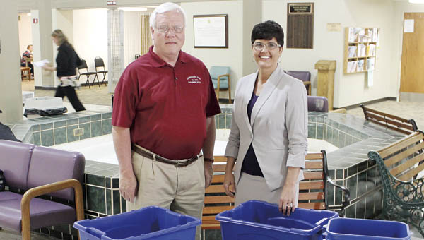 Dan Palmer, Scioto-Lawrence Solid Waste Management District coordinator, and Ironton Mayor Katrina Keith stand with the new recycling containers the Ironton City Center has received. The center is one of the newest recycling locations for the solid waste district.
