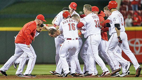 Cincinnati outfielder Scott Schebler is mobbed by teammates after his game-winning double in the bottom of the ninth gave the Reds a 3-2 win over Philadelphia on Wednesday. (Photo Courtesy of The Cincinnati Reds.com)